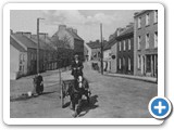 Mr Mc Knight and Janey Bell at the Water Pump, With Meeting House Street in the background, c1920 1930, Courtesy 
Strabane Weekly
